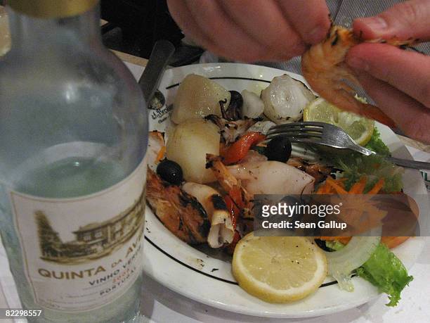 Guest enjoys seafood and vinho verde at Cafe Brasileira on Rua Garrett on July 23, 2008 in Lisbon, Portugal. Portugal is becoming an increasingly...