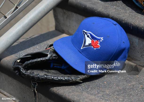 Detailed view of a Toronto Blue Jays baseball hat and glove sitting on the dugout steps during the game against the Detroit Tigers at Comerica Park...