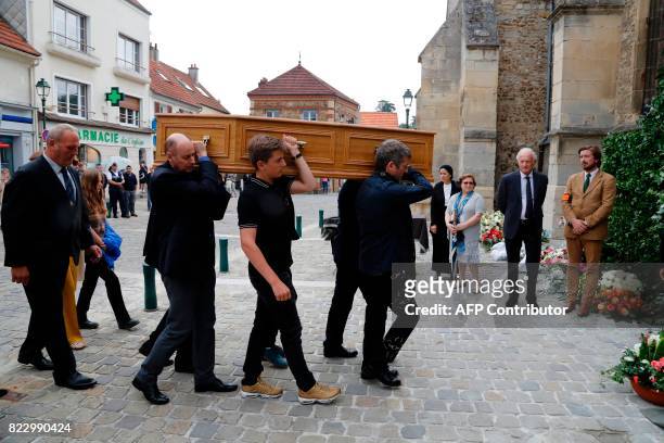 Coffin bearers carry the coffin of late French actor Claude Rich for the funeral ceremony into the Saint Pierre - Saint Paul Church in Orgeval,...