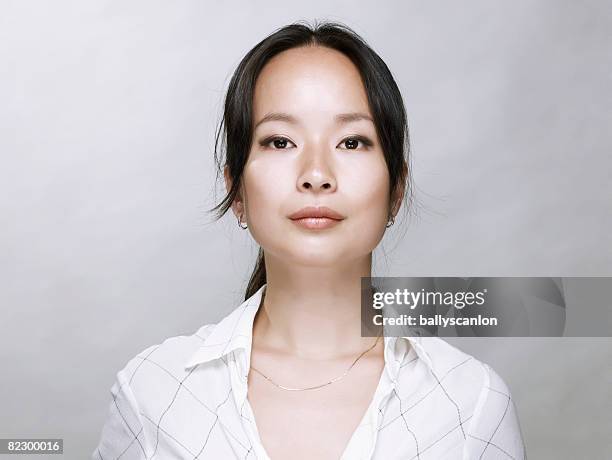 young asian woman, looking at camera. - financial strength stock pictures, royalty-free photos & images