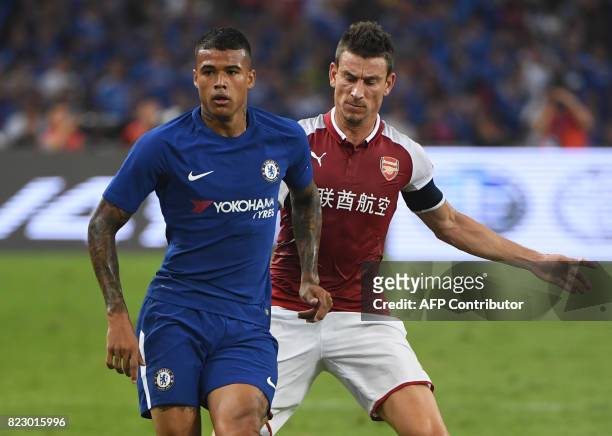 This photo taken on July 22, 2017 shows Chelsea's Kenedy competing for the ball with Arsenal's Laurent Koscielny during their pre-season football...