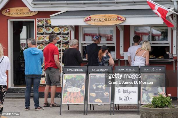 Holidaymakers queue for lunch on July 26, 2017 in Hornbaek, Denmark. Known locally as the Danish Riviera, Hornbaek attracts thousands of...