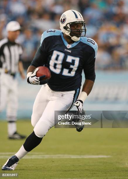 Tight end Alge Crumpler of the Tennessee Titans finds some running room after catching a pass against the St. Louis Rams during a pre-season game at...