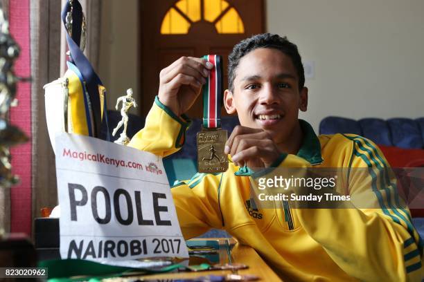 South African high jumper Breyton Poole (17 poses with his gold medal during an interview at his home on July 20, 2017 in Cape Town, South Africa....