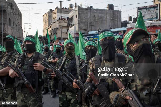 Palestinian Hamas militants are seen during a military show in the Bani Suheila district on July 20, 2017 in Gaza City, Gaza. For the past ten years...