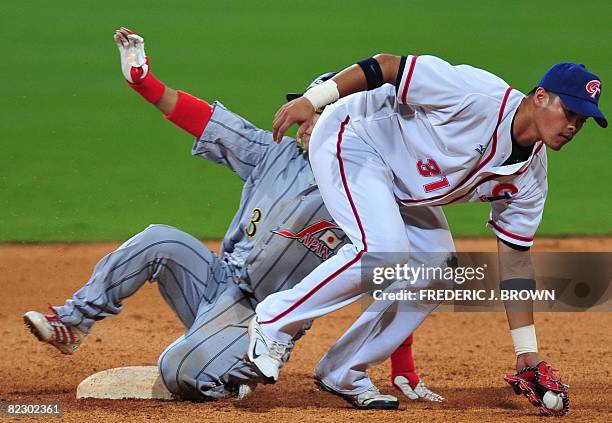 Japan's Hiroyuki Nakajima beats the throw into second ahead of the tag by Taiwan's Lin Chih-Sheng in the top of the ninth inning in their men's...