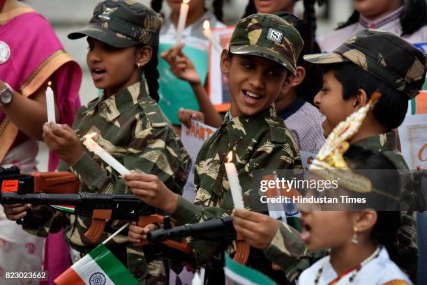 Students and people from NGO participate in a candlelight vigil on the eve of Kargil Vijay Diwas on July 25, 2017 in Bengaluru, India. Kargil Vijay...