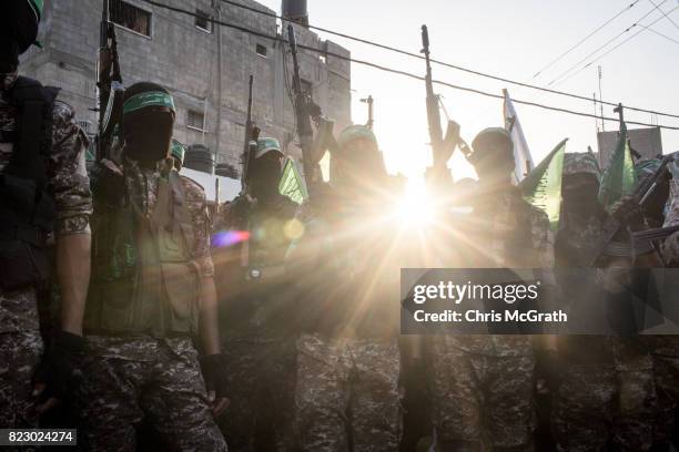 Palestinian Hamas militants are seen during a military show in the Bani Suheila district on July 20, 2017 in Gaza City, Gaza. For the past ten years...