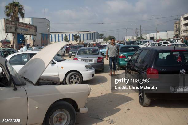 Man looks over cars for sale at a used car market in Gaza City, Gaza. For the past ten years Gaza residents have lived with constant power shortages,...