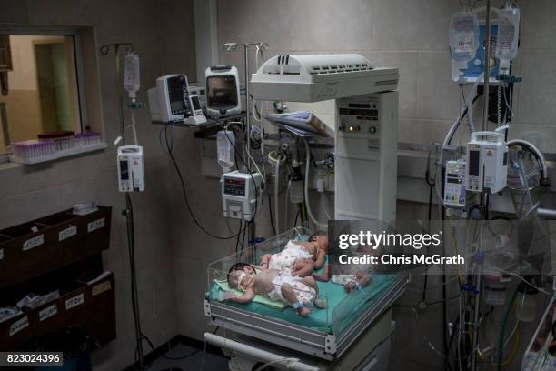 Newborn babies suffering from various medical complications are seen hooked up to medical equipment in the neonatal unit at Shifa hospital on July...