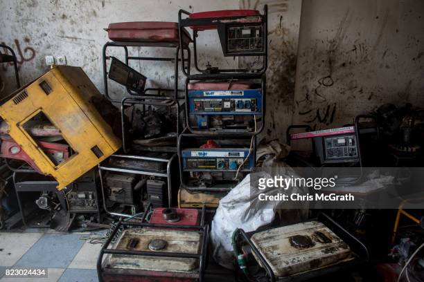 Old generators are seen stacked up at a generator repair shop on July 20, 2017 in Gaza City, Gaza. For the past ten years Gaza residents have lived...