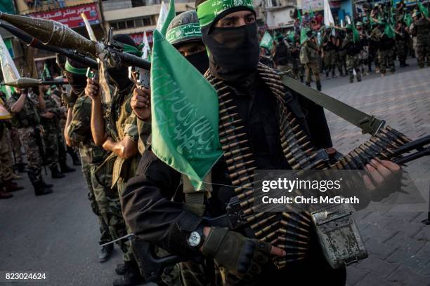 Palestinian Hamas militants are seen during a military show in the Bani Suheila district on July 20, 2017 in Gaza City, Gaza. For the past ten years...