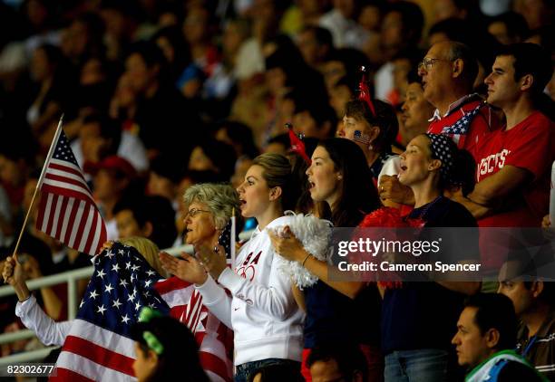 Fans of the United States cheer from the stands as their team takes on Bulgaria during the men's volleyball event held at the Institute of Technology...