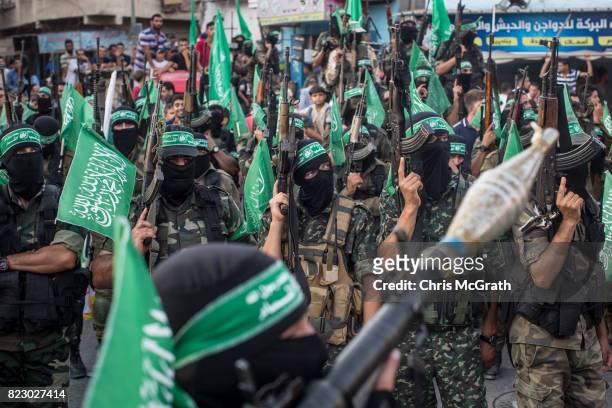 Palestinian Hamas militants are seen during a military show in the Bani Suheila district on July 20, 2017 in Gaza City, Gaza. For the past ten years...
