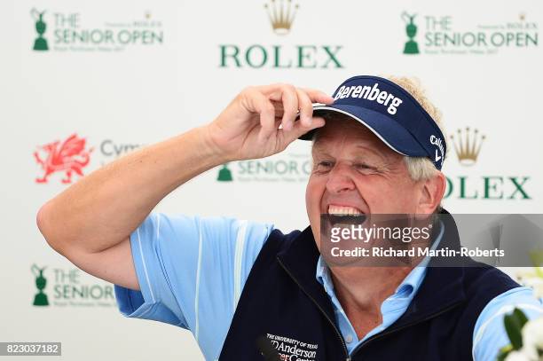 Colin Montgomerie of Scotland answers questions from the media at a press conference during a practice round prior to the Senior Open Championship at...