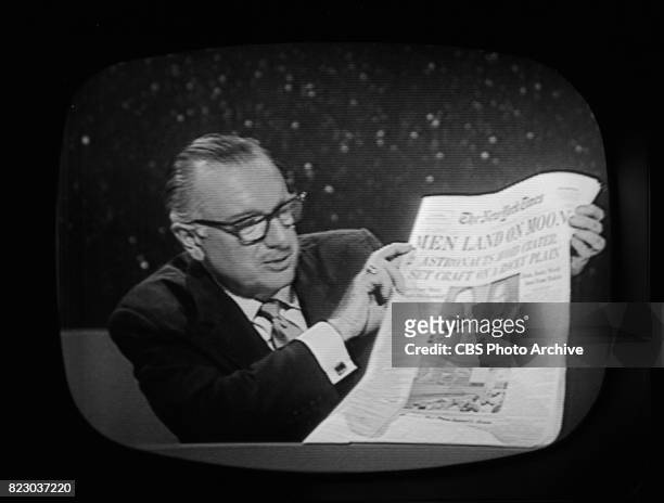 Anchor Walter Cronkite holds up The New York Times during the Apollo 11 telecast, July 20, 1969 at 10:11 PM. Image is a frame grab.
