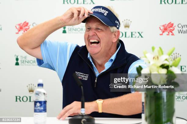 Colin Montgomerie of Scotland answers questions from the media at a press conference during a practice round prior to the Senior Open Championship at...