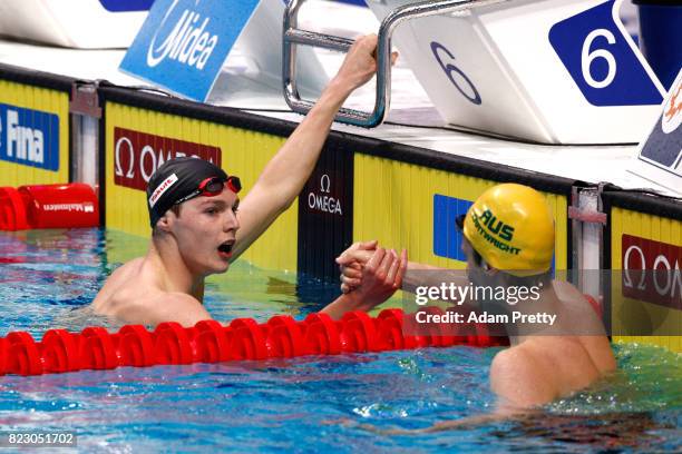 Duncan Scott of Great Britain shakes hands with Jack Cartwright of Australia following the Men's 100m Freestyle semi final on day thirteen of the...