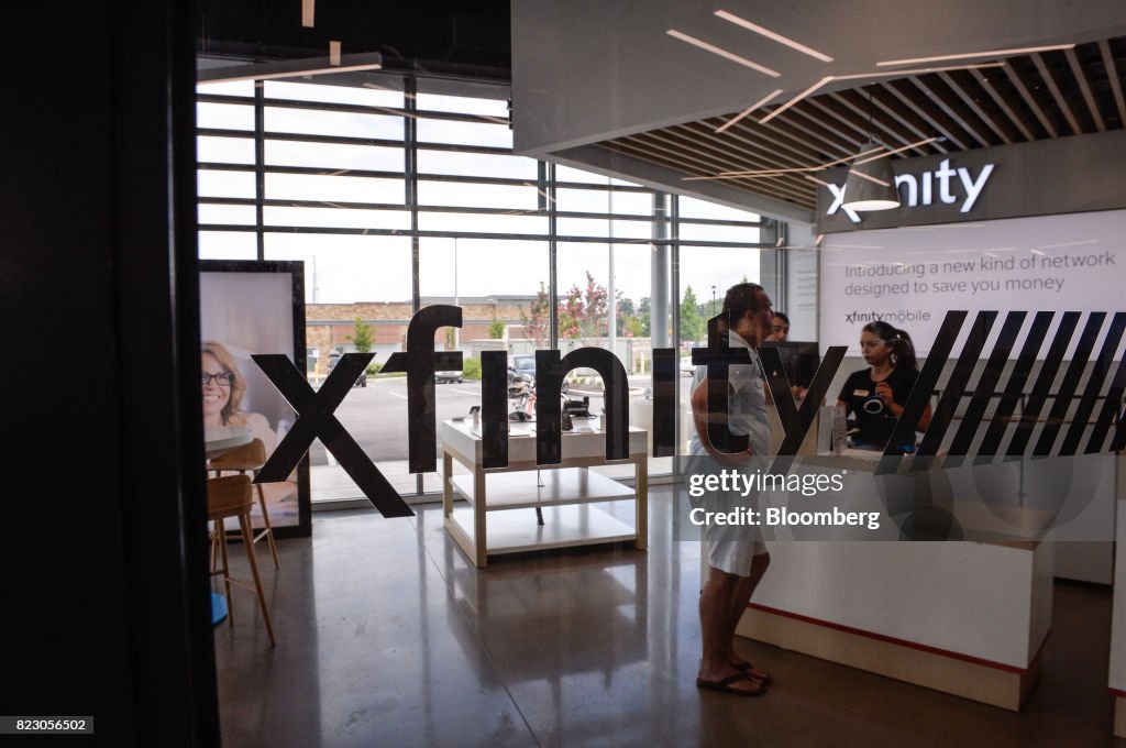 Xfinity Image Signage is displayed in the window of a Comcast Corp. Xfinity store ...