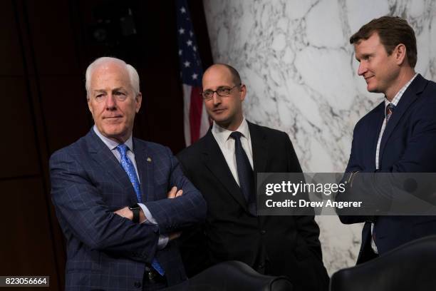 Sen. John Cornyn talks with aides before the start of a Senate Judiciary Committee hearing titled 'Oversight of the Foreign Agents Registration Act...