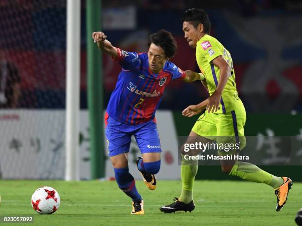 Sei Muroya of FC Tokyo and Kosei Shibasaki of Sanfrecce Hiroshima compete for the ball during the J.League Levain Cup Play-Off Stage first leg match...