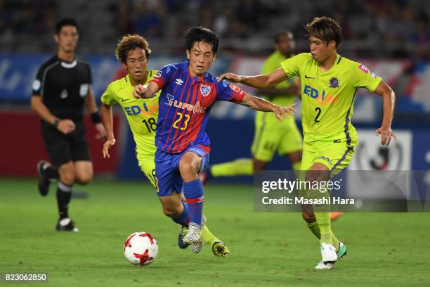 Shoya Nakajima of FC Tokyo and Yuki Nogami of Sanfrecce Hiroshima compete for the ball during the J.League Levain Cup Play-Off Stage first leg match...