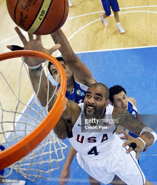 Carlos Boozer of the USA shoots as Ioannis Bourousis and Dimitrios Diamantidis defend during the Men's Preliminary Round Group A basketball game...