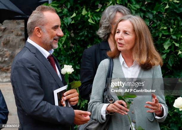 French actor Antoine Dulery speaks with French architect and French actor Jean Rochefort's wife Françoise Vidal after a funeral ceremony for late...