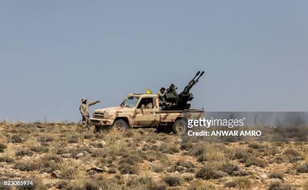 Picture taken on July 26, 2017 during a tour guided by the Lebanese Shiite Hezbollah movement shows members of the group manning an anti-aircraft gun...
