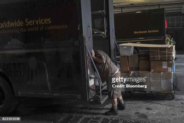 United Parcel Service Inc. Delivery driver loads packages from truck onto a dolly for delivery in New York, U.S, on Monday, July 24, 2017. United...