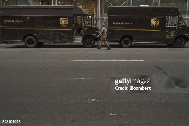United Parcel Service Inc. Delivery driver walks towards a deliver truck parked on a street in New York, U.S, on Monday, July 24, 2017. United Parcel...