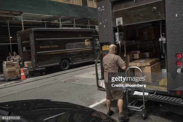 United Parcel Service Inc. Delivery driver loads packages onto a delivery truck in New York, U.S, on Monday, July 24, 2017. United Parcel Service...