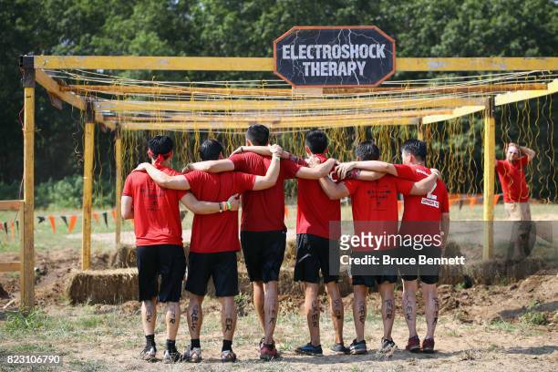 Participants take part in Tough Mudder Long Island at the Old Bethpage Village Restoration on July 22, 2017 in Old Bethpage, New York.