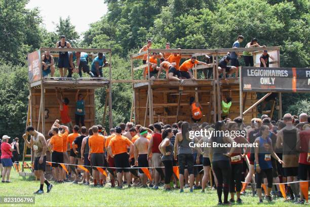 Participants take part in Tough Mudder Long Island at the Old Bethpage Village Restoration on July 22, 2017 in Old Bethpage, New York.