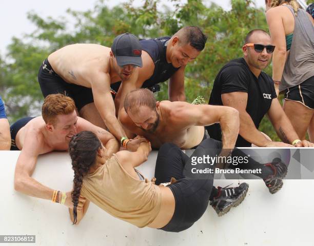 Participants take part in Tough Mudder Long Island at the Old Bethpage Village Restoration on July 22, 2017 in Old Bethpage, New York.