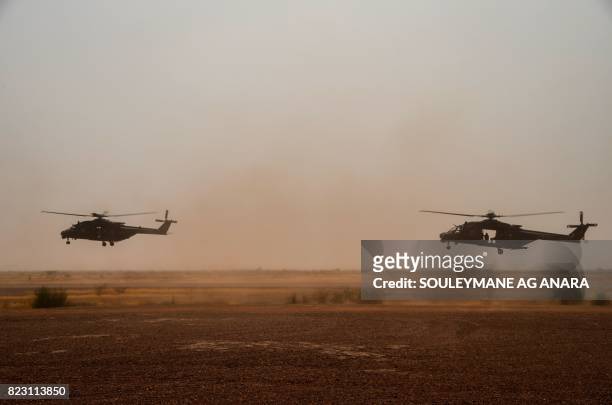 Photo taken on July 25, 2017 shows NH90 Caiman transport helicopters piloted by German soldiers taking off from Gao airport in Mali. - A German...