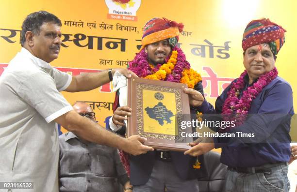 Rajasthan Sports Minister Gajendra Singh Khinvsar giving award to Sundar Singh Gujjar, gold medalist, World Para-Athletics Championships at SMS...