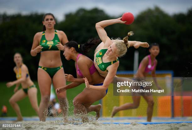 Heather Cooper of Australia is challenged by Nien-En Hsieh of Chinese Taipei during the Beach Handball Women's Group B match between Australia and...