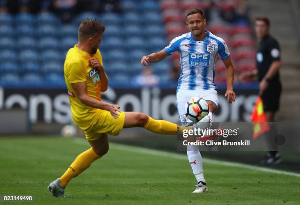 Chris Lowe of Huddersfield Town in action with Silvan Widmer of Udinese during the pre season friendly match between Huddersfield Town and Udinese at...