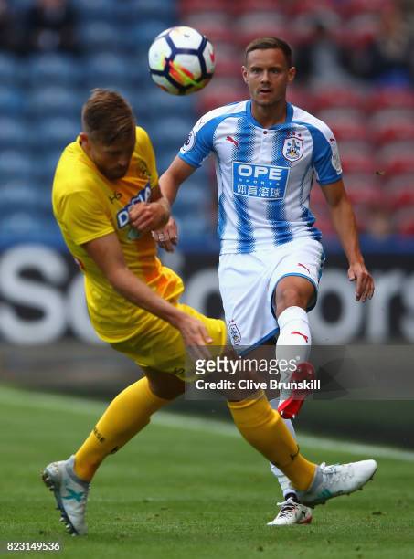 Chris Lowe of Huddersfield Town in action with Silvan Widmer of Udinese during the pre season friendly match between Huddersfield Town and Udinese at...