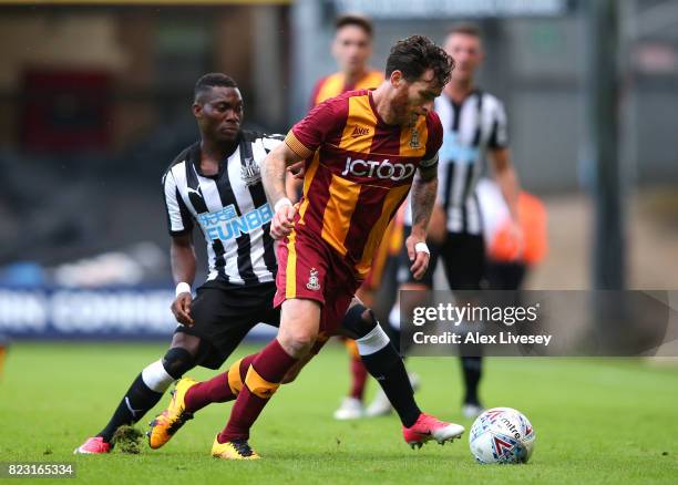 Romain Vincelot of Bradford City beats Christian Atsu of Newcastle United during a pre-season friendly match between Bradford City and Newcastle...