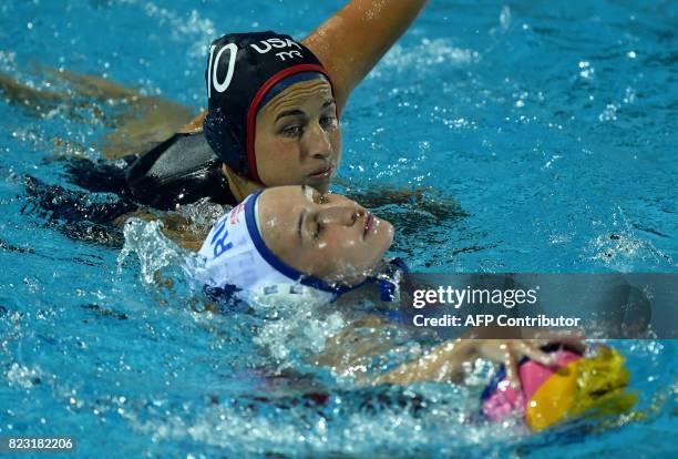 Jamie Neushul fights for the ball with Russia's Elvina Karimova in 'Hajos Alfred' swimming pool on July 26, 2017 in Budapest during a semifinal match...