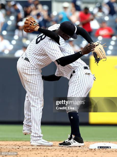 Didi Gregorius and Ronald Torreyes of the New York Yankees celebrate the 9-5 win over the Cincinnati Reds on July 26, 2017 at Yankee Stadium in the...