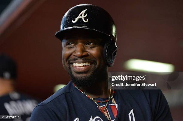 Brandon Phillips of the Atlanta Braves smiles in the dugout after scoring against the Arizona Diamondbacks in the first inning at Chase Field on July...