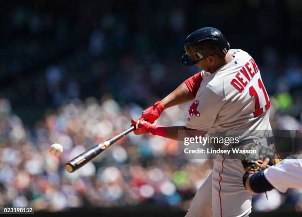 Rafael Devers of the Boston Red Sox makes contact for his first career hit, a home run to center field off of Andrew Moore of the Seattle Mariners in...