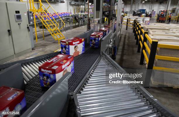 Boxes of Huggies brand diapers move along a conveyor belt at the Kimberly-Clark Corp. Manufacturing facility in Paris, Texas, U.S, on Tuesday, Oct....