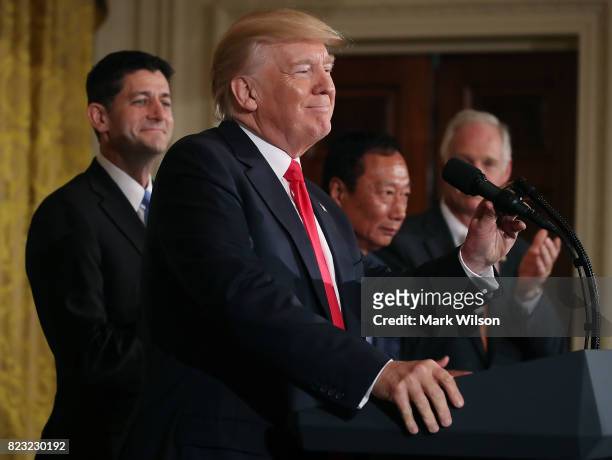 President Donald Trump while flanked by House Speaker Paul Ryan , Terry Gou , Chairman of Foxconn, an electronics supplier, and Sen. Ben Johnson...