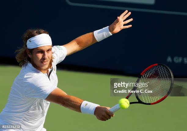 Lukas Lacko of Slovakia returns a backhand to Donald Young during the BB&T Atlanta Open at Atlantic Station on July 26, 2017 in Atlanta, Georgia.