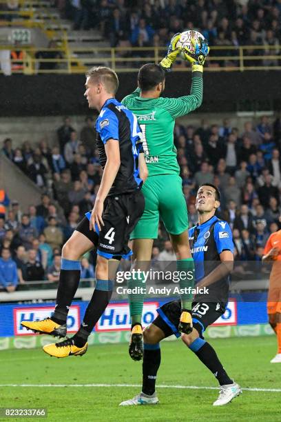 Goalkeeper Volkan Babacan from Istanbul Basaksehir catches the ball, denying Bjorn Engels from Club Brugge while Jeremy Perbet from Club Brugge looks...