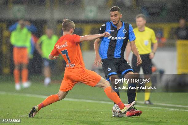 Edin Visca From Istanbul Basaksehir challenges Jelle Vossen from Club Brugge during the Champions League Third Round Qualifier First Leg match...